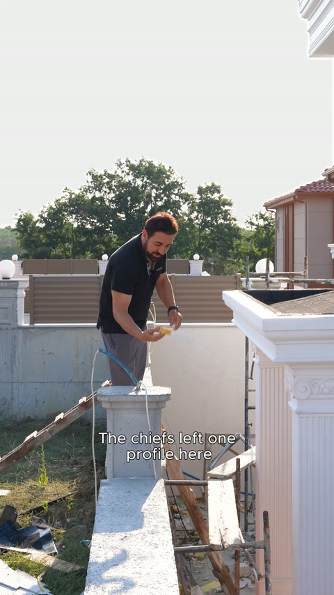 The presenter checks the wide crown profile on the terrace parapet with a hammer.