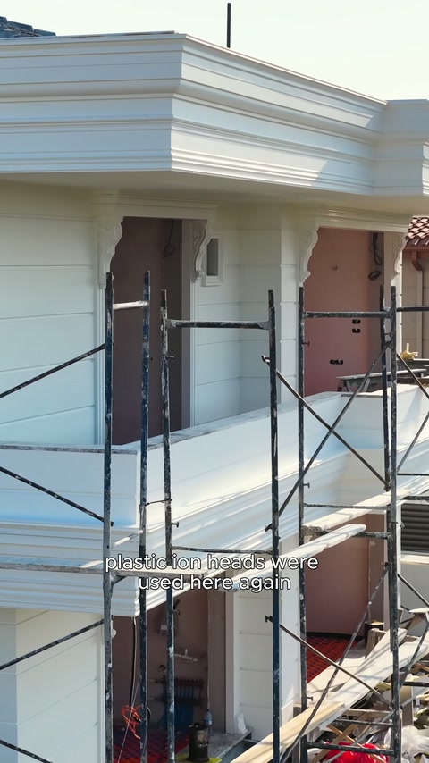 Soffit profiles meet cladding surfaces at the construction site entrance.