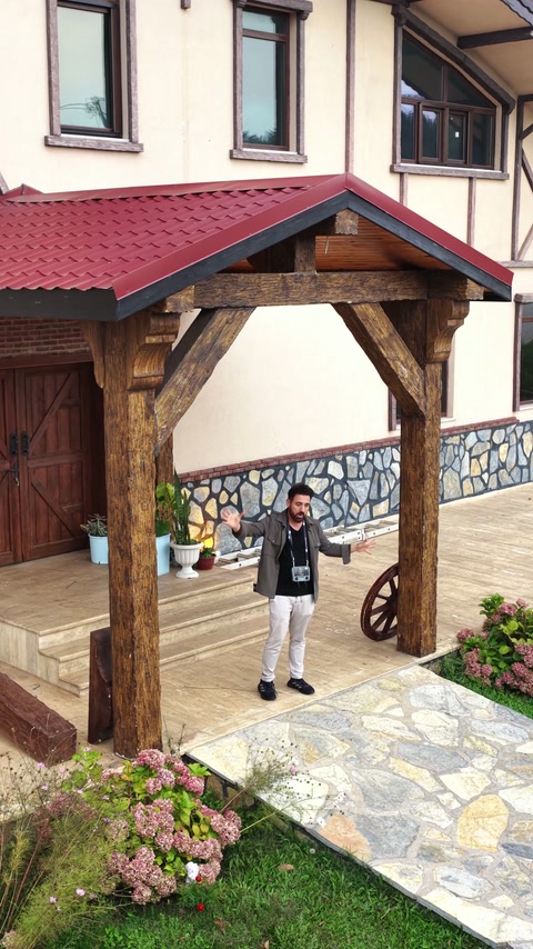 Wide facade view shows the rustic entrance beneath red roofing.