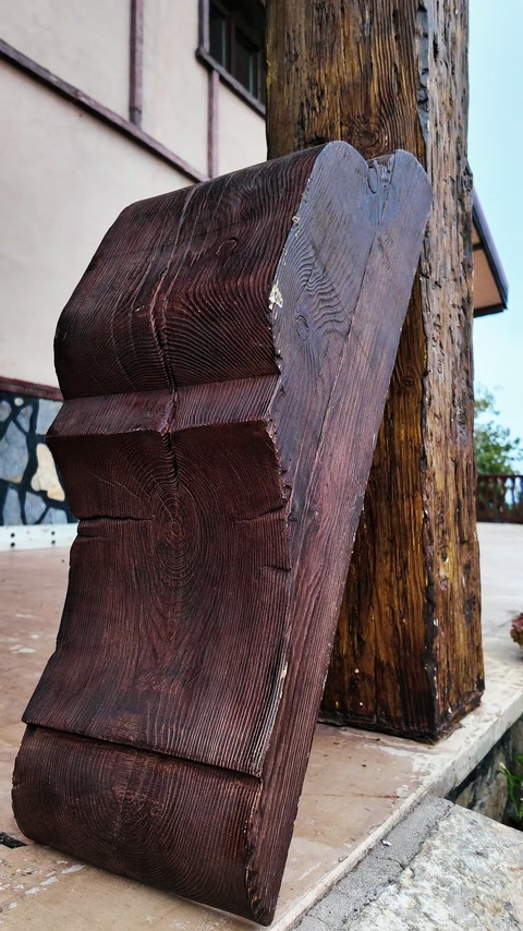 Freestanding curved bracket displays layered contours and carved wood texture.