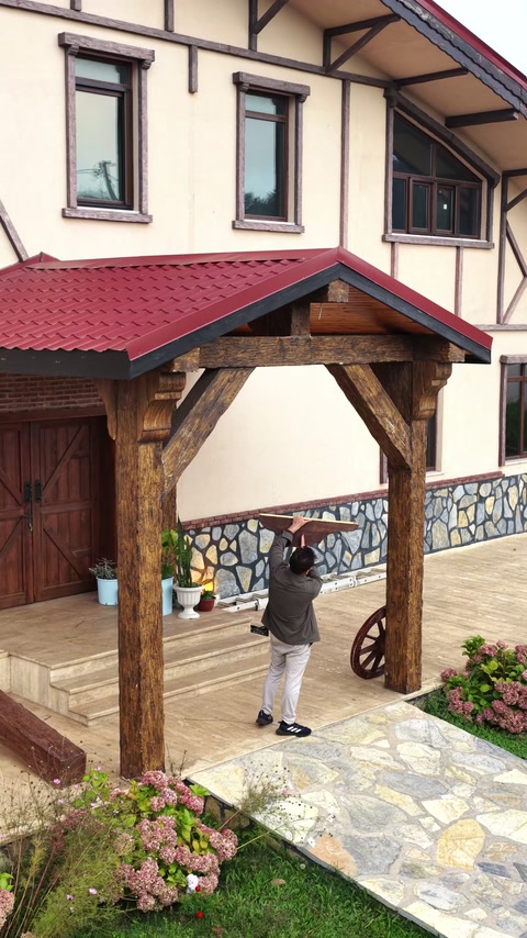 Side perspective connects the timber-look entrance with stone landscaping.