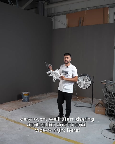 Installation technician standing in the studio with a screw gun in hand