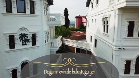 Balcony surrounds, window trims, and decorative column details on the side facade