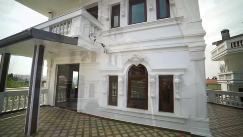 An arched doorway surrounded by horizontal facade bands on the main entrance