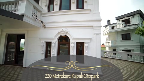 Columns and a decorative pediment framing the arched villa entrance