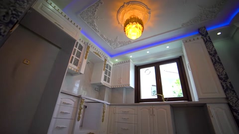 Cornice molding, corner details, and ceiling lighting in a room with windows