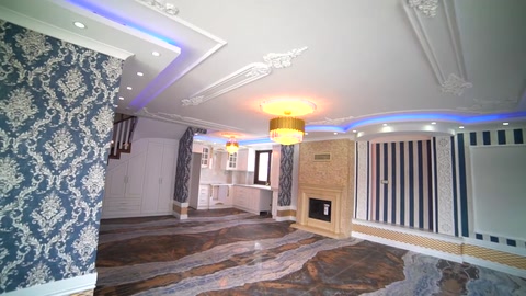 A patterned living room wall, cornice ceiling, and surrounding lighting