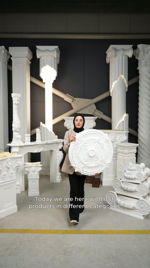 The presenter showcases an embossed circular ceiling rose positioned between decorative columns from the front.