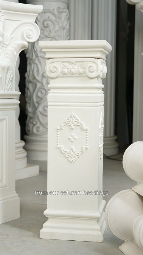 A rectangular decorative base with a framed rosette motif stands in the showroom.