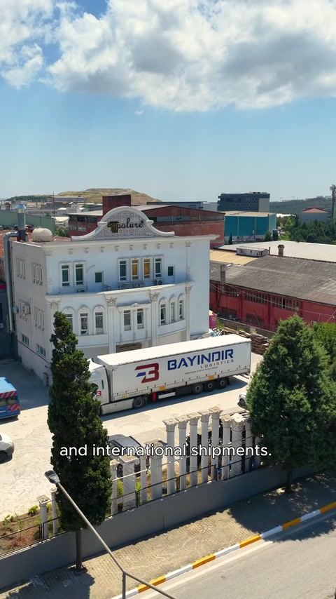 The production facility and delivery truck are shown together from above.