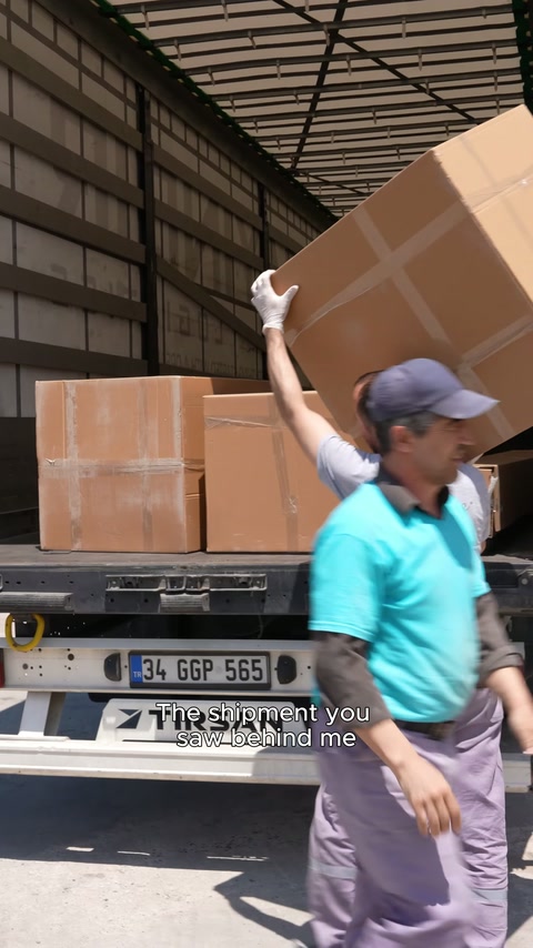 The team transfers a packaged decorative product to the stack inside the vehicle.
