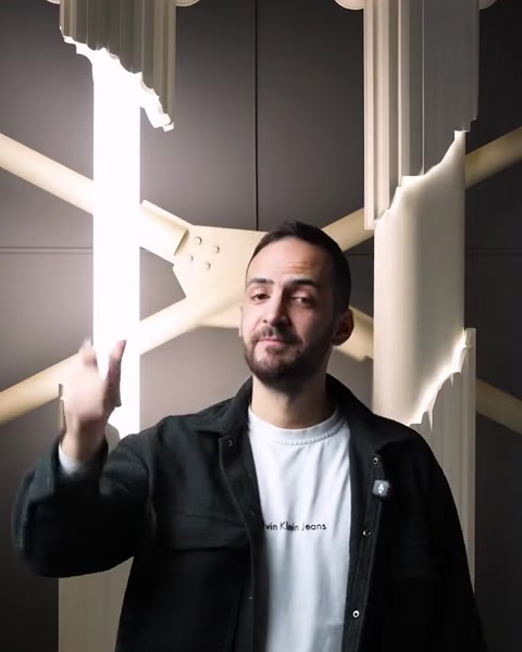 Man presenting illuminated polyurethane columns with hidden LED strips indoors