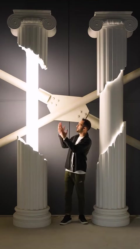 Man touching decorative column showing integrated LED lighting detail