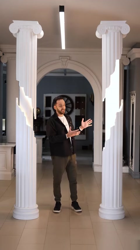 Interior hallway with arched doorway and matching decorative columns