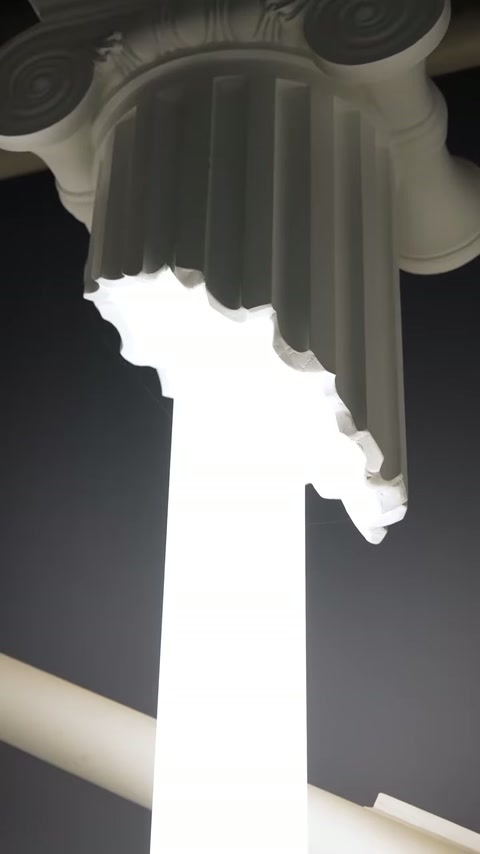 Ornate column capital surrounds a brightly illuminated central translucent section.