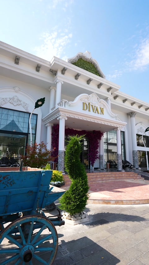 Landscaped entry area completed with elegant columns, wide cornice and embossed details.