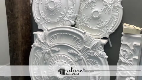 Three different ceiling medallion designs are displayed together in the workshop