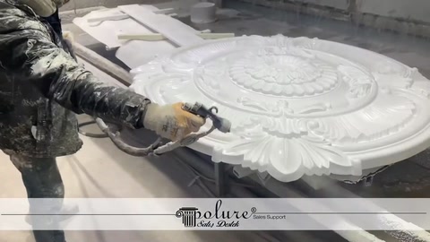 A coating is applied to the surface of a ceiling medallion by spraying