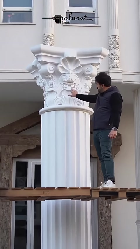 A craftsman checks the joined Corinthian capital and column shaft