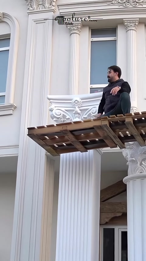 A craftsman presents different capital and column models together