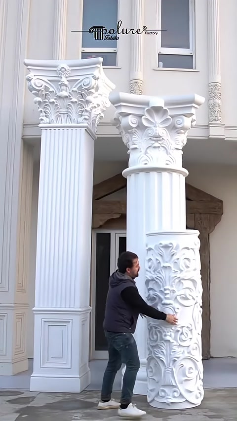 A relief-patterned column base is placed around the fluted shaft