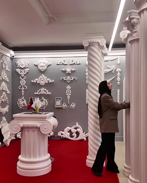 A slender fluted column with an Ionic capital and base is displayed