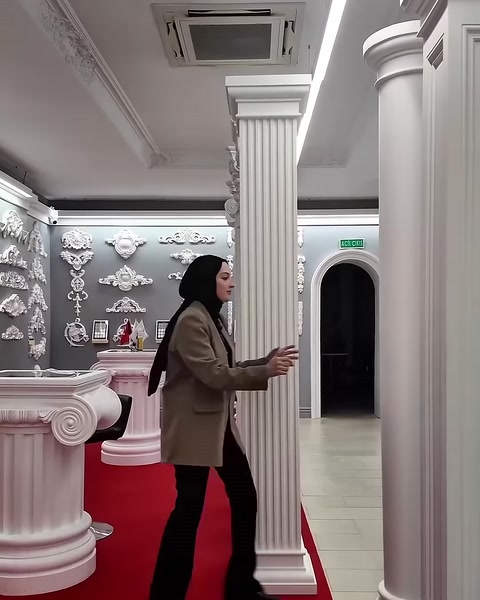 A rectangular paneled column shaft is presented inside the showroom