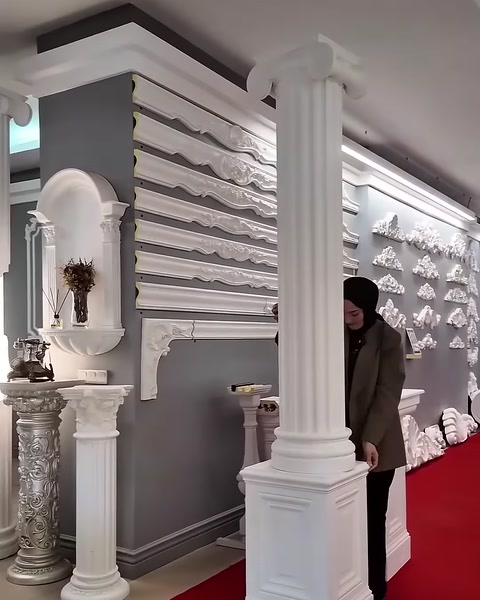 The simple capital and base design of a slender fluted column is shown