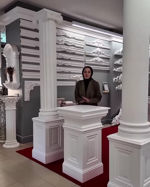 The column varieties and decorative wall ornaments in the showroom are visible