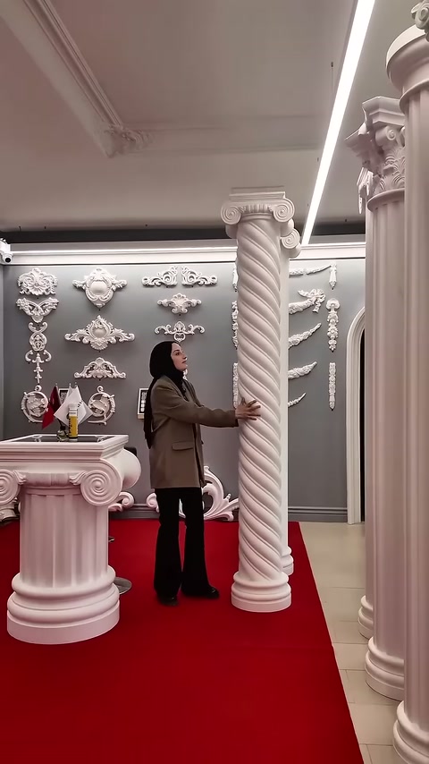 L'addetto indica con la mano i dettagli del fusto a disegno spiralato della colonna