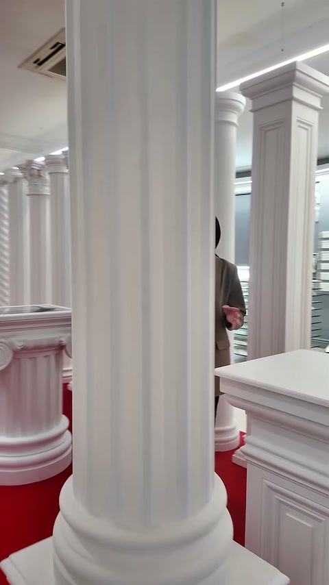 Close view highlights deep fluting and molded base of column.