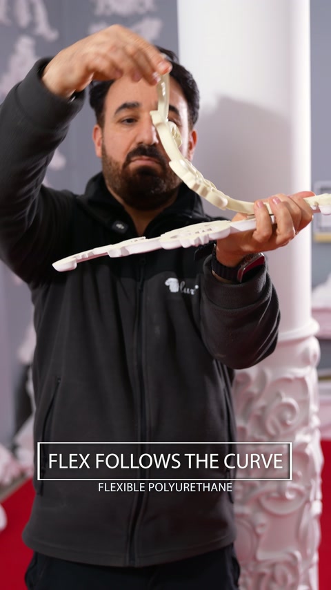 Demonstrator bends a flexible polyurethane ornament to show its pliability.