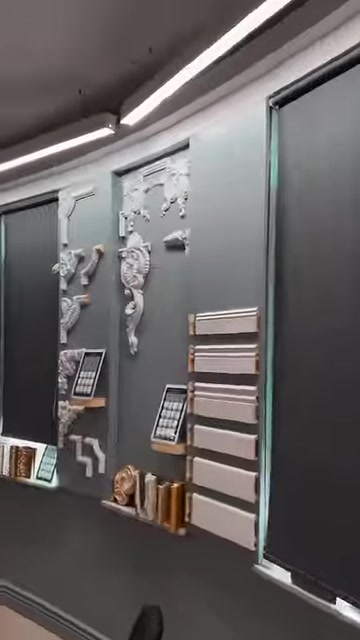 Cornice profiles and decorative wall ornaments shown on a showroom display panel