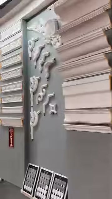 Profiles and embossed corner motifs are featured on a gray showroom wall