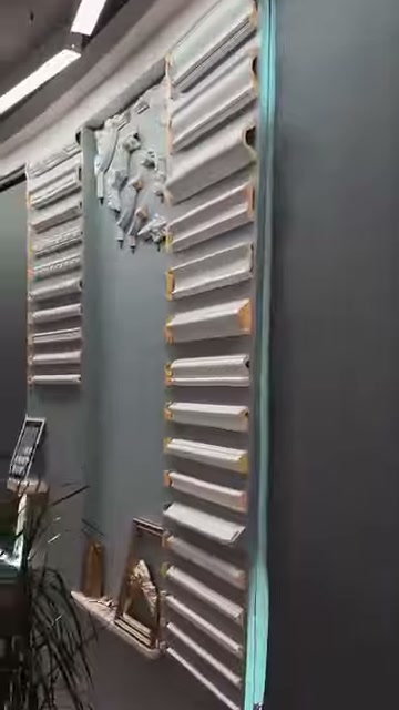 A wall section containing cornice sections is viewed from the side