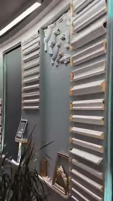 Numerous flat profiles are placed horizontally on a gray display surface