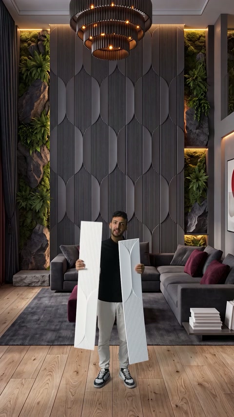 Designer presents white decorative panels before a dark living room installation