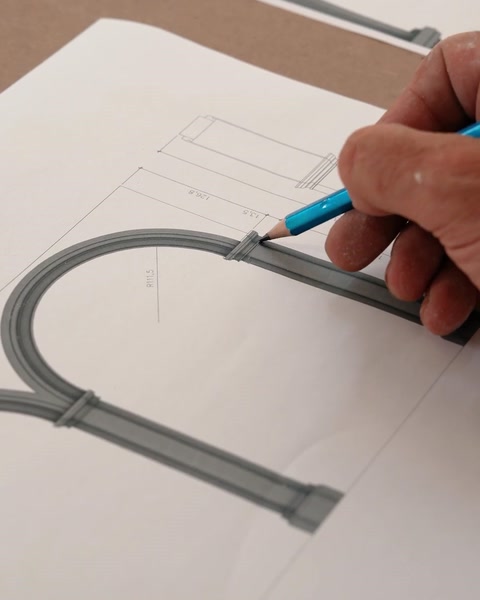 Hand drawing the arch profile geometry on technical paper