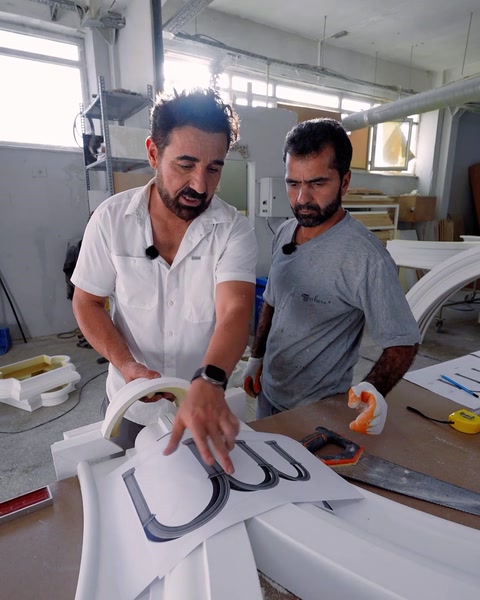 Team checking arch templates and profile drawings on the workbench