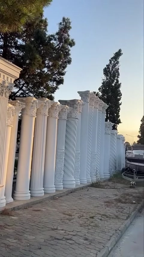 Decorative columns with different shaft patterns are lined up outdoors