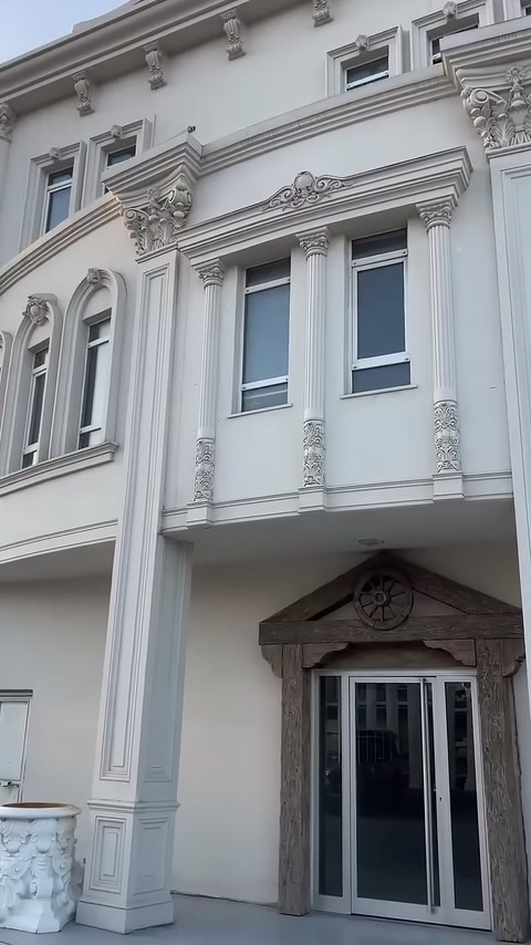 Ornamental column capitals on the building facade complement the window surrounds