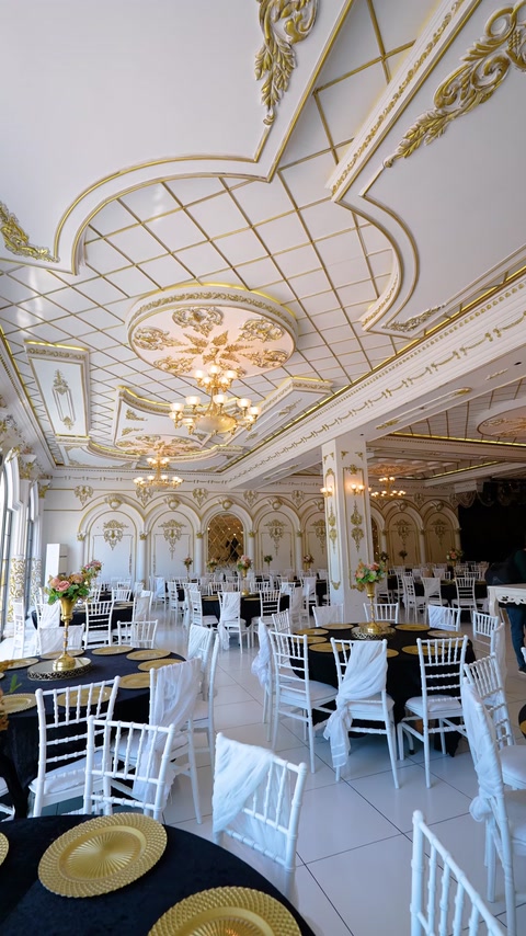 Banquet hall with coffered gold ceiling and crystal chandeliers