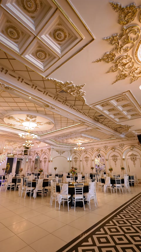 Wide ballroom view showing grid ceiling molding and gold trim