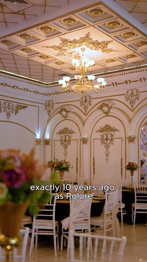 Gold ceiling medallions above dining tables under crystal chandeliers