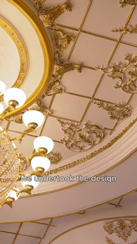 Close-up chandelier mounted on ornate coffered ceiling panel