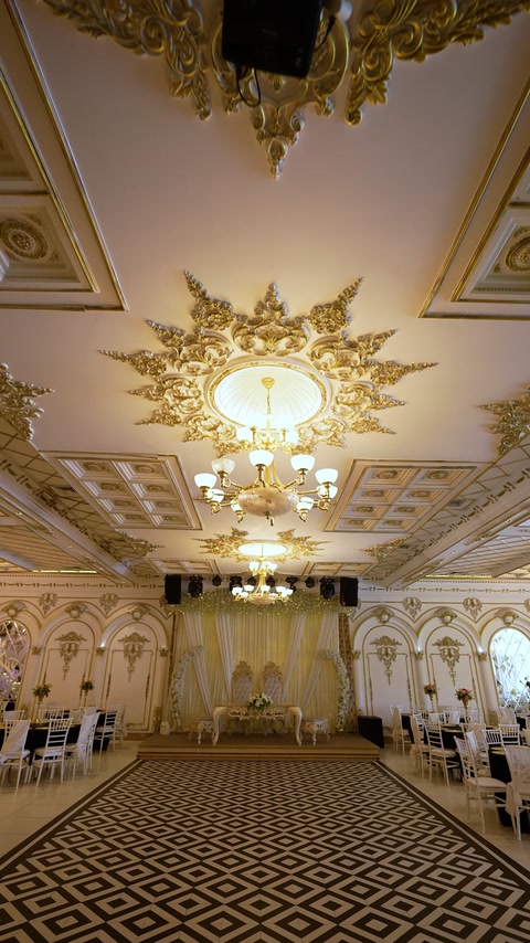 Wedding stage area with draped backdrop and ornate ceiling
