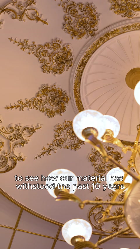 Domed ceiling section with pendant light and gold trim