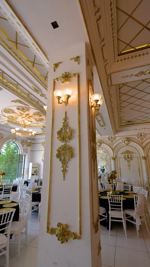 Gold-trimmed column with applique panel near window