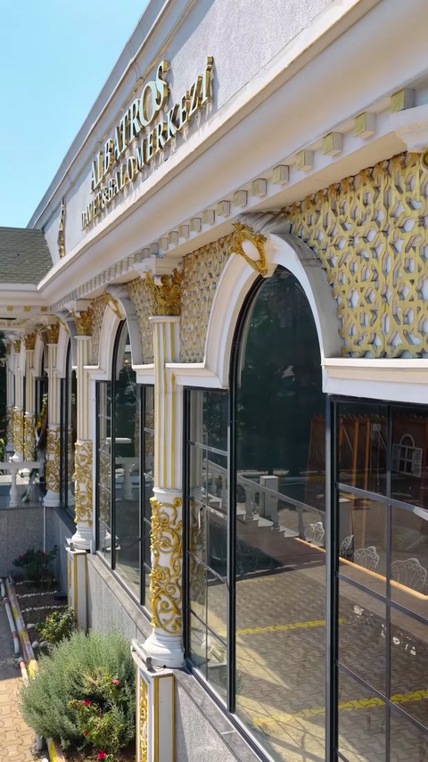 Building facade with arched glass windows and decorative columns
