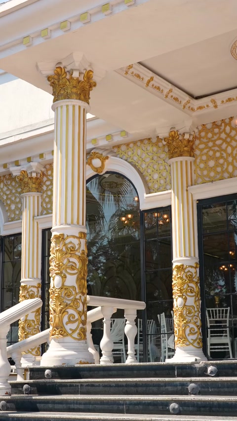 Close-up exterior column base with gold capital detail